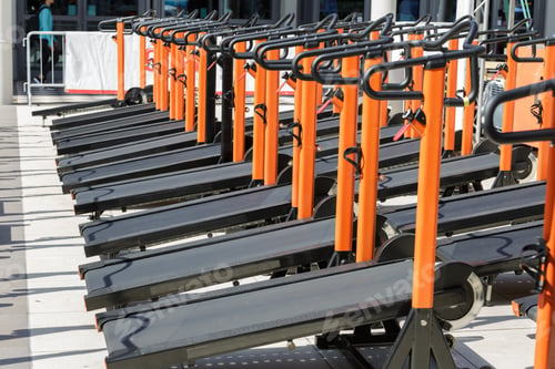 Preview: Group Of Modern Orange Treadmill In Line In Fitness Center.