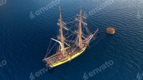 Preview: Aerial Drone Photo Of Wooden Sail Boat Docked Near Old Port Of Santorini Island In Deep Blue Sea