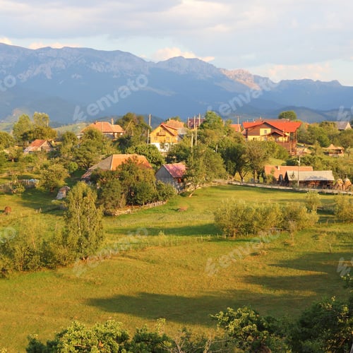 Preview: Piatra Craiului National Park In Romania - Mountain Landscape With Small Village In Sunset Light