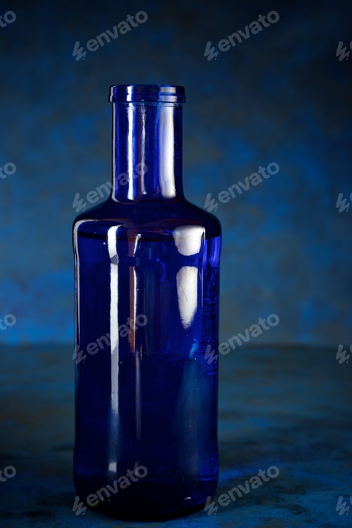 Preview: Blue Glass Bottle On A Table.