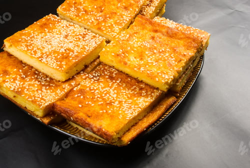 Preview: Slice Of Cheesecake With Sesame Seeds On A Black Background