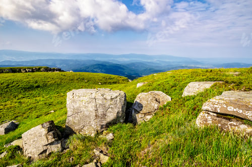 Preview: Mountain Summer Landscape. Meadow With Huge Stones Among The Grass On Top Of The Hillside Near The