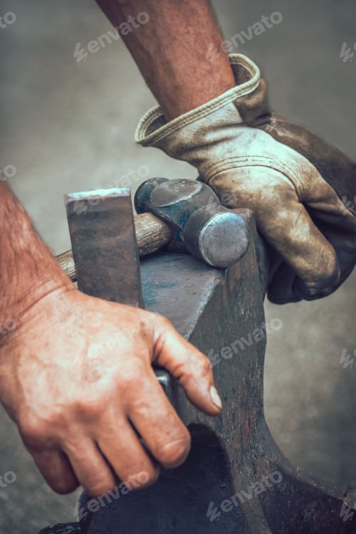 Preview: A Blacksmith Resting His Hands On Anvil After Work At Medieval Fair Festival In Streatham Park In