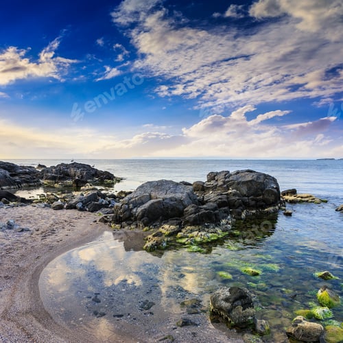 Preview: Morning Sea Shore Landscape With Boulders Sand And Seaweed