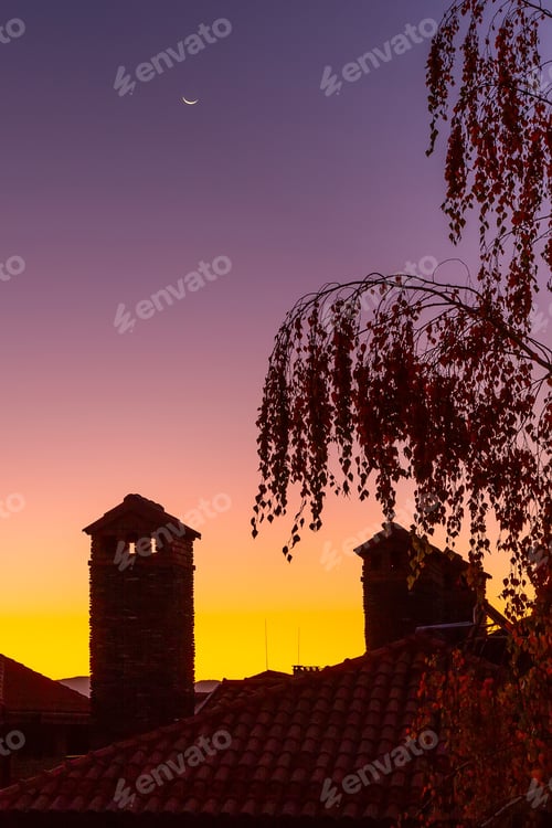 Preview: Waning Crescent Moon, Dawn Purple And Orange Colorful Background With Tree And Houses Silhouette