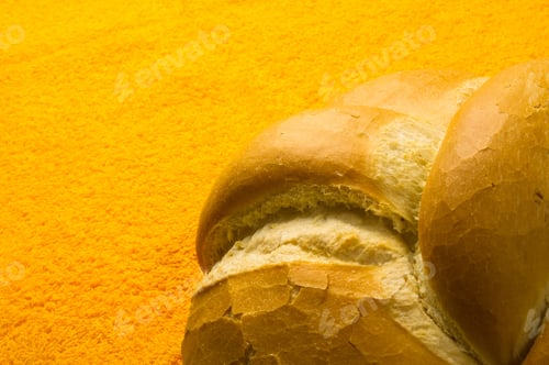 Preview: Fresh Braided Loaf Of White Wheat Bread On An Yellow Napkin