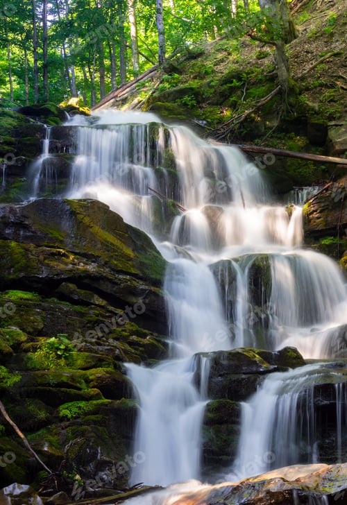 Preview: Cascades Of Big Waterfall In Forest. Beautiful Summer Scenery At Sunrise. Beams Of Light On Water
