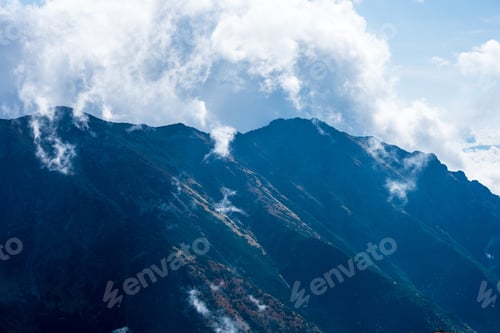Preview: Slovakian Tatra Mountain High Peaks On The Blue Sky Background With Broken Clouds And Sun In Summer