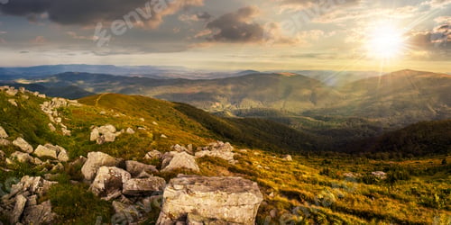 Preview: Mountain Panorama Landscape. Valley With Stones In Grass On Top Of The Hillside Of Mountain Range