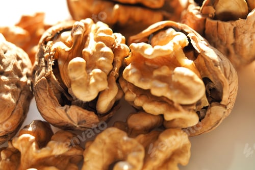 Preview: Close Up Macro Photo Of Walnut Kernels And Shells As Seen In White Background