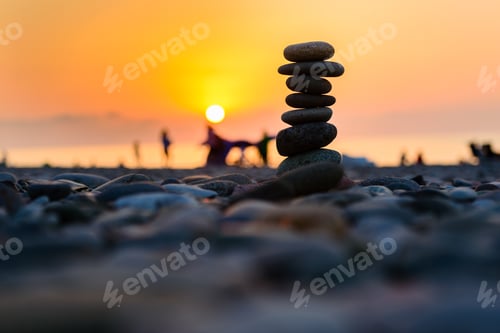 Preview: Stones Pyramid On Sand Symbolizing Zen, Harmony, Balance. Black Sea At Sunset In The Background.