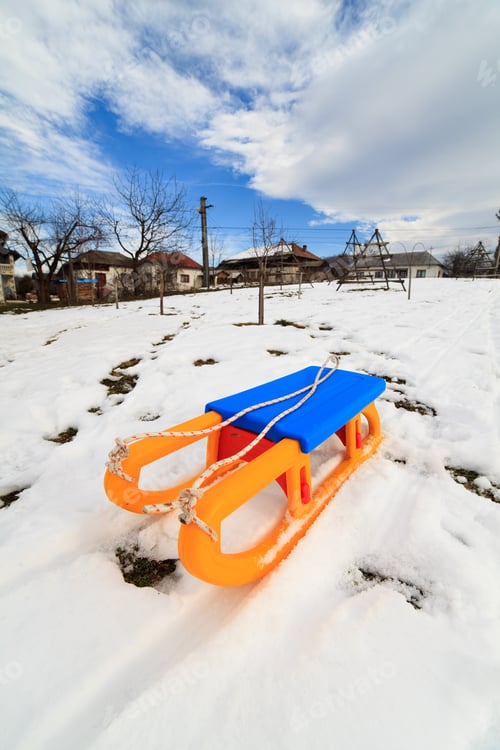 Preview: Countryside View With A Plastic Yellow And Blue Sledge