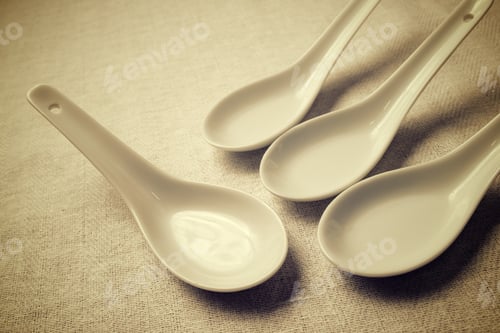 Preview: Small White Spoons On A White Tablecloth