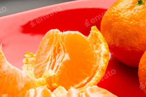 Preview: Tangerines, Peeled Tangerine And Tangerine Slices In A Red Plate On Black Background