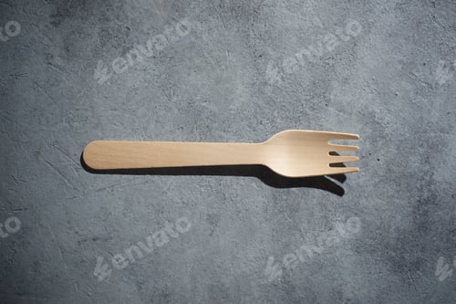 Preview: Disposable Wooden Cutlery On A Stone Table.