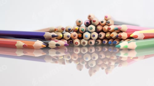 Preview: Group Of Sharp Colored Pencils With White Background And Reflexions