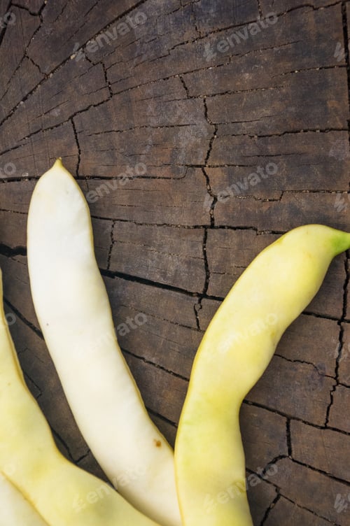 Preview: Large Pods Of White Beans On Old Wooden Background