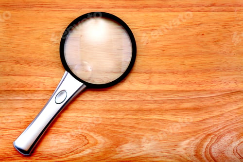 Preview: Magnifying Glass Lying On The Wooden Table
