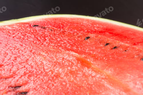 Preview: Half Of Ripe Watermelon On A Black Background