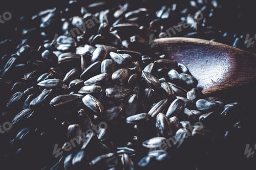 Preview: Fried Sunflower Black Seeds With A Wooden Spoon In A Pan, Close-Up