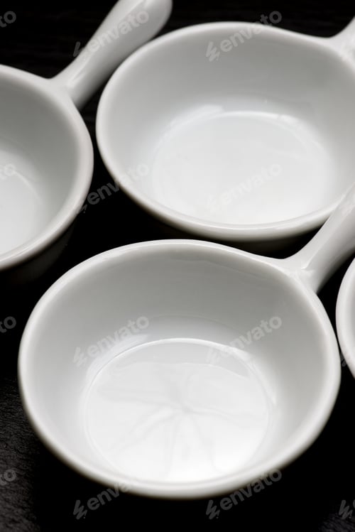 Preview: Four Small White Spoons On A Table Slate
