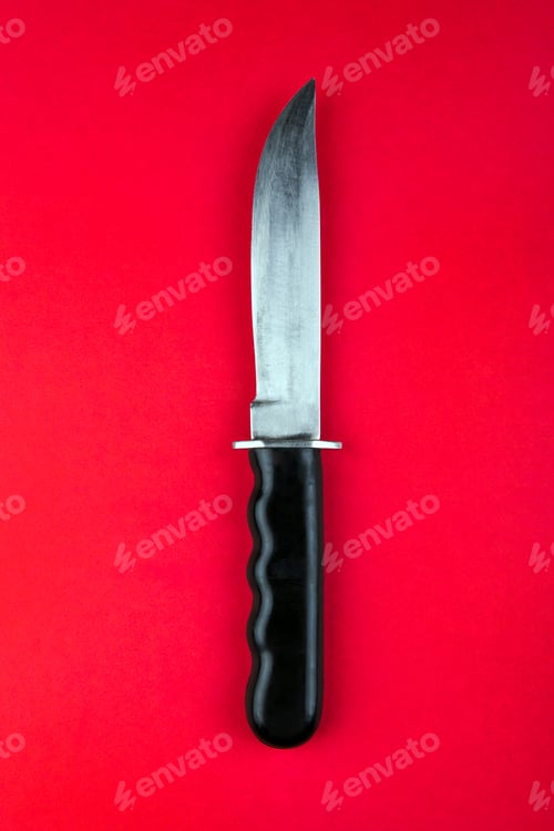 Preview: Knife On The Red Paper Background Closeup