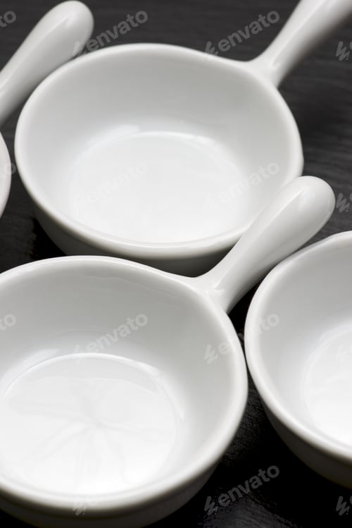 Preview: Four Small White Spoons On A Table Slate
