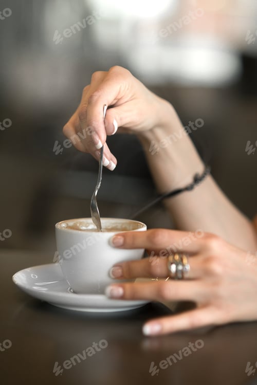 Preview: Close View. Beautiful Female Hands Stir Sugar In Coffee. Great Taste And Exquisite Aroma Of Coffee.