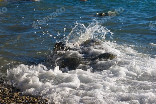 Preview: Rocky Sea Shore With Pebble Beach, Transparent Waves With Foam, On A Warm Summer Day