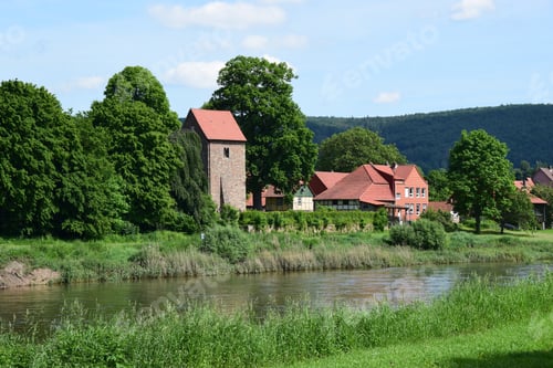 Preview: The Idyllic Village Hemeln At The River Weser With Medieval Church Tower