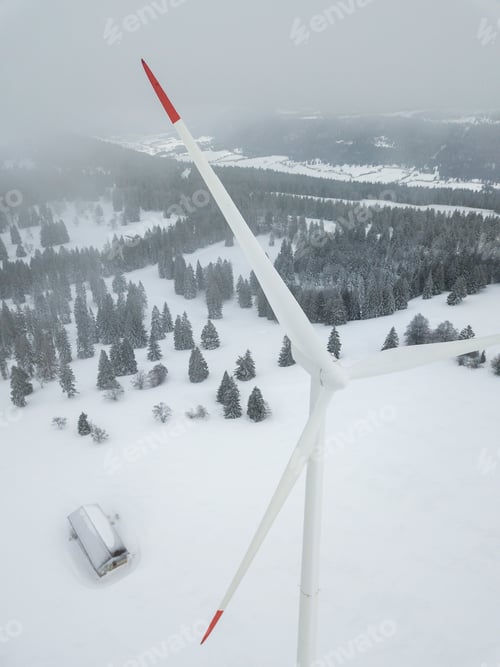 Preview: Aerial View Of Wind Turbine In Snow Covered Landscape In Switzerland. Tall Pylon In Fog, Fir Trees
