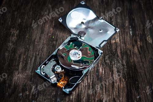 Preview: Crushed Hard Disk Drive On The Old Wooden Table