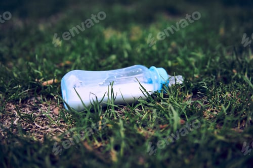Preview: Lost Milk Bottle For The Baby Lies Among The Grass
