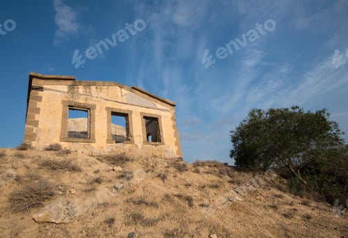 Preview: Deserted Abandoned House On The Top Of A Cliff And Blue Cloudy Sky.