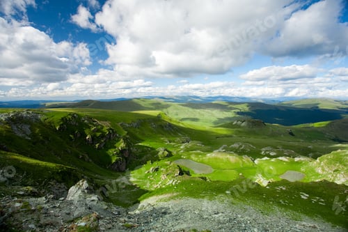 Preview: Beautiful Landscape With Mountains And Fluffy Clouds In The Sky