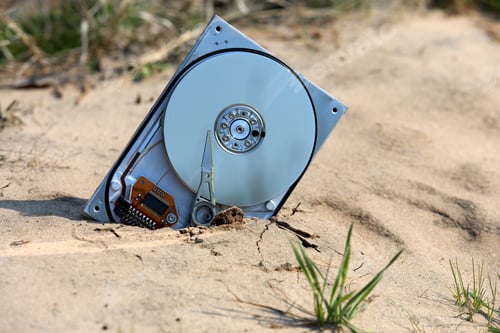 Preview: Abstract Broken Computer Hard Drive In The Sand