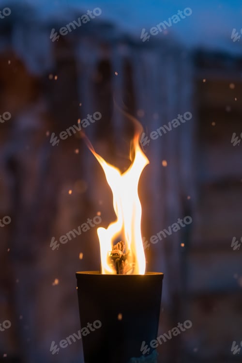 Preview: Fire Burning Inside Metal Torch In Front Of A Wooden Shed In A Sami People Village, Northern Norway