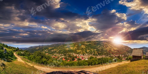Preview: Summerlandscape. Village On The Hillside Between The Mountain At Sunset