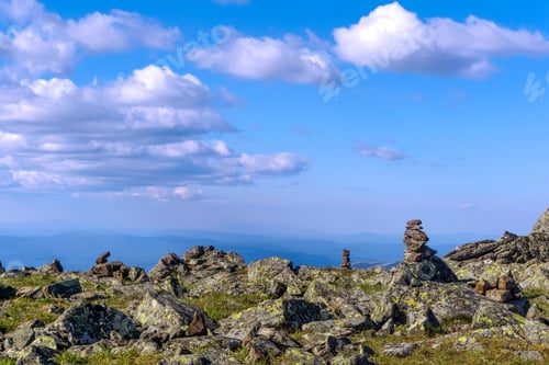 Preview: Bright Landscape Of A High-Altitude Plateau With Folded Travelers Pyramids Cairns Of Stones Under A