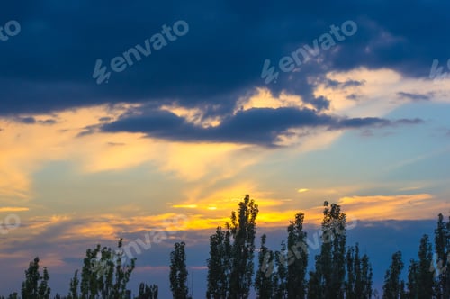 Preview: Landscape With Dramatic Light - Orange Clouds And The Outline Of Trees At Sunset