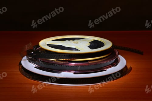 Preview: Old Film Reels On The Table In The Dark Room