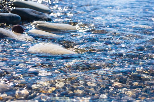 Preview: Sea Pebble Beach With Multicoloured Stones, Transparent Waves With Foam, On A Warm Summer Day