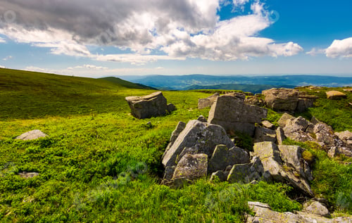 Preview: Boulders On Top Of Runa Mountain. Beautiful Landscape With Distant Peak Under The Cloud On A Blue