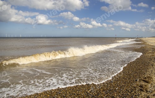 Shingle Beach With Waves Washing Ashore.