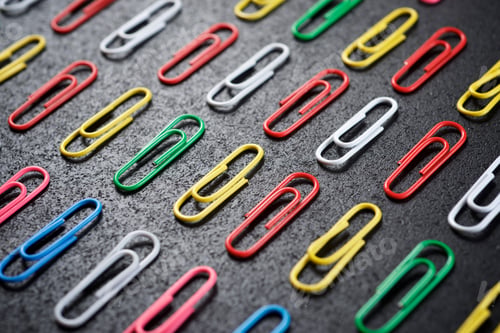 Preview: Paperclips Group On A Black Table.