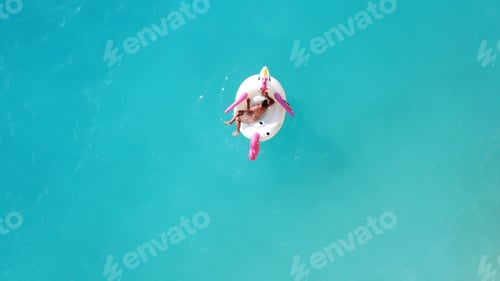 Preview: Aerial Drone Top Photo Of Unidentified Man Sitting In Inflatable Unicorn In Tropical Paradise Beach