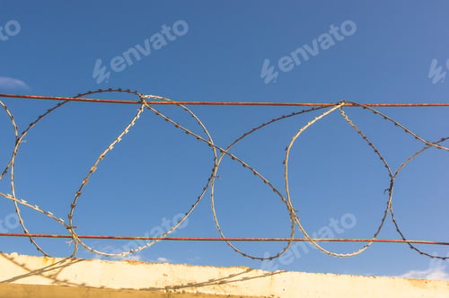 Preview: Wall With Barbed Tape On Blue Sky Background