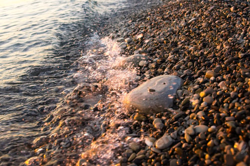 Preview: Sea Pebble Beach With Multicoloured Stones, Transparent Waves With Foam, On A Warm Evening