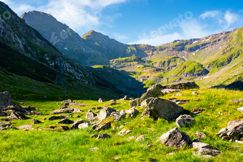 Preview: Lovely Scenery Of Transfagarasan Road In Valley. Rocks On Grassy Meadow And Slopes. Half Of The