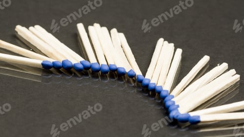 Preview: Unused Matches With Blue Head Screw On Dark Background